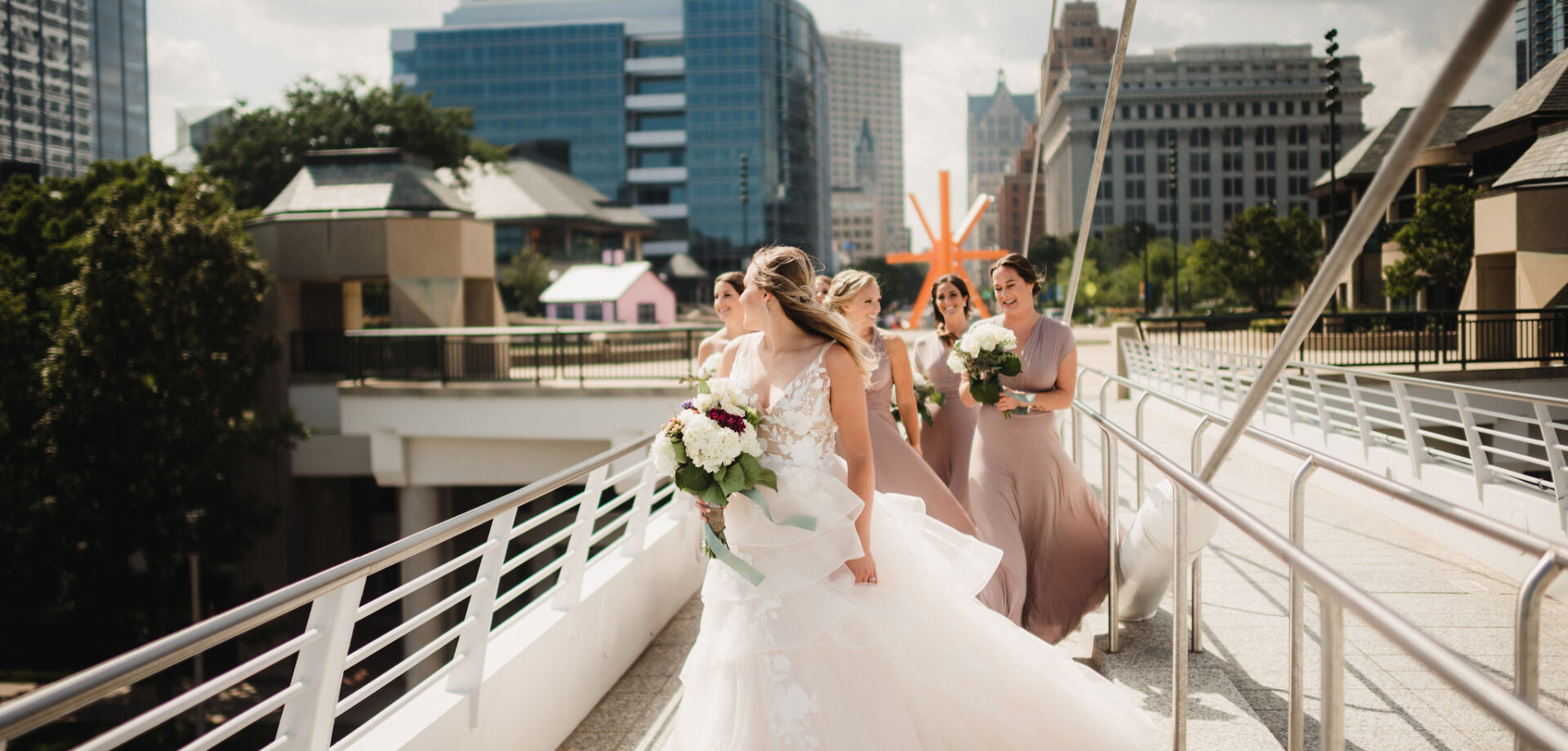 Bridal party walking lakeside on dock