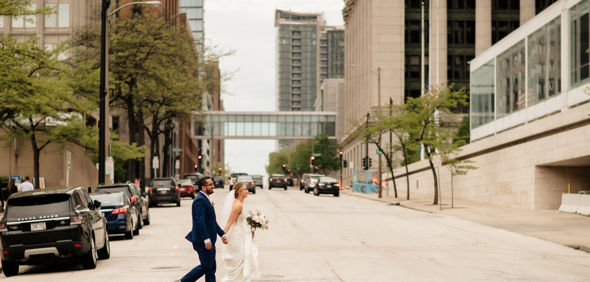 Bride and groom walking in downtown Milwaukee