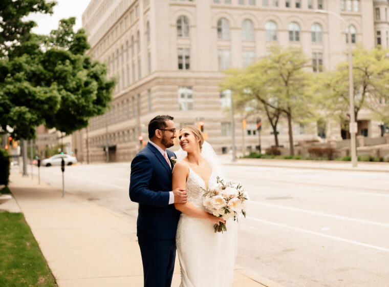 Couple in front of stone building in Downtown Milwaukee