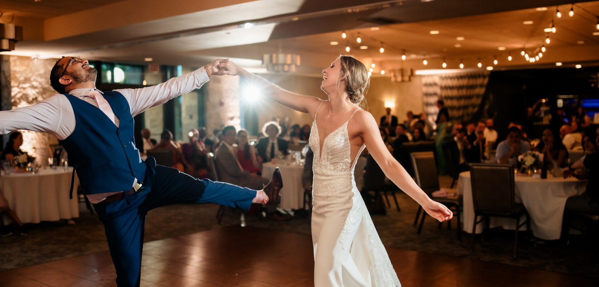 Bride twirling groom during first dance