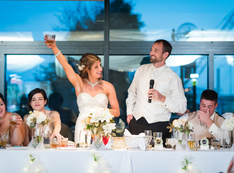 bride and groom cheers from head table